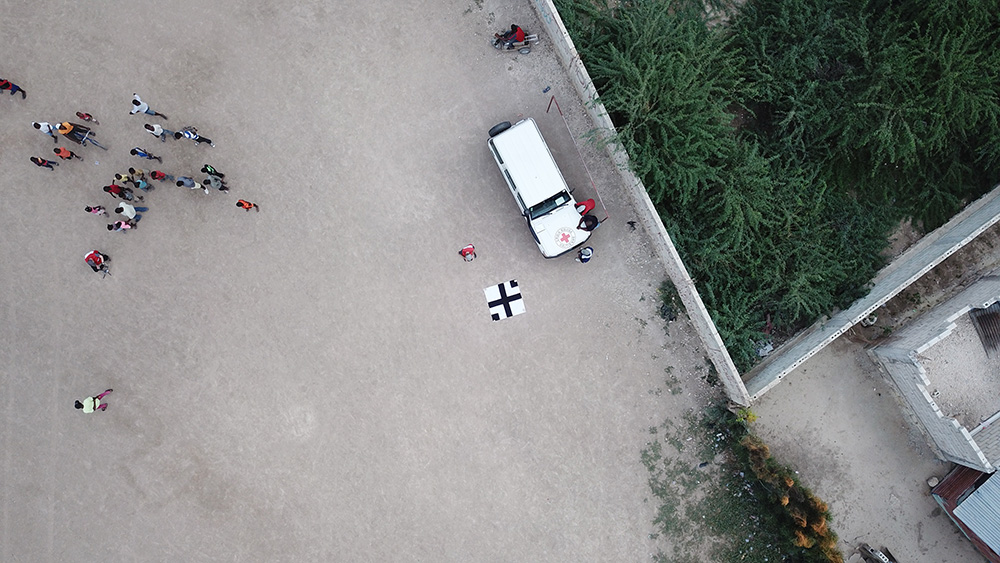 Aerial view from a drone of a Haitian Red Cross Land Cruiser.