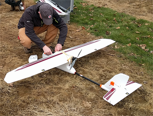 Matthew Gibb prepares an Event 38 E384 fixed wing mapping drone for launch.