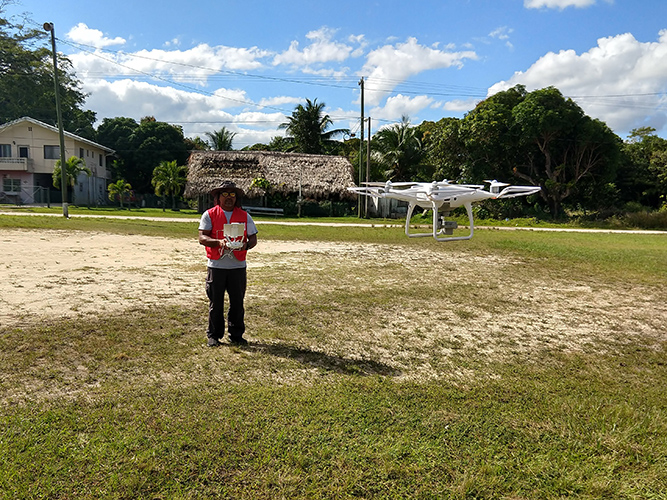 Terence Woodye of the Belize Red Cross practices flying a DJI Phantom drone.